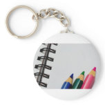 Colour pencils on a notepad keychains