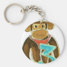 Cowboy Monkey Holding Three Keychains