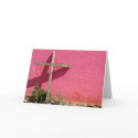 cross leaning on pink wall cards