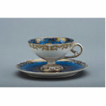 Cup and saucer with colorful designs cut out