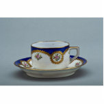 Cup and saucer with colorful designs cut out