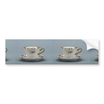 Cup and saucer with colourful flowers on it. bumper stickers
