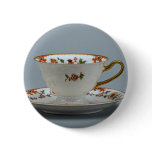 Cup and saucer with colourful flowers on it. pinback button
