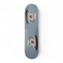 Cup and saucer with colourful flowers on it. skate boards