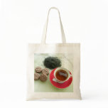 Cup of black tea with chocolate biscuits bags