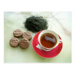 Cup of black tea with chocolate biscuits postcard