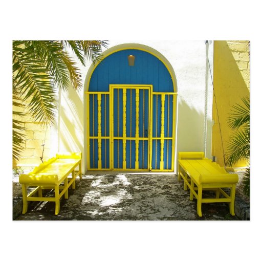 Decorated blue door with yellow benches postcards