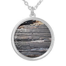 Detail of burnt wooden log with damaged surface pendant