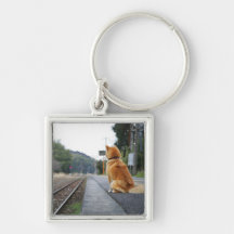Dog sitting on train station key chain