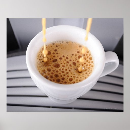 Espresso pouring into cup posters