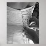 Female hand lacing up wedding dress back posters