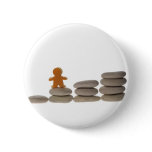 Figurine on stack of pebbles pinback button