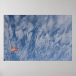 Flag beneath clouds poster
