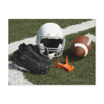 Football, football helmet, tee and shoes on postcard