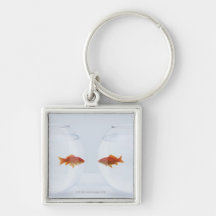 Goldfish in separate fishbowls looking face to key chain