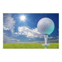 golf ball on a tee with grass posters