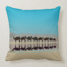 Group of camels walking in desert pillows