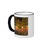 Group of people sitting at a sidewalk cafe, mug