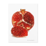 Half a ripe pomegranate cut to expose the juicy postcards