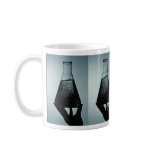 Hand holding an attractive laboratory beaker mugs