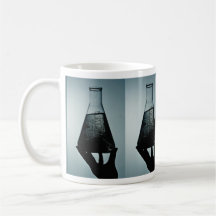 Hand holding an attractive laboratory beaker mug