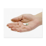 Hand holding pills postcards