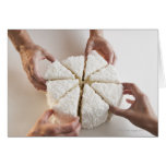 Hands pulling slices from cake greeting card