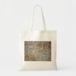 Hieroglyphics on a stone wall tote bag