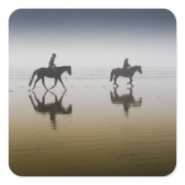 Horse riders at the beach square sticker