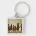 Horses cresting small hill during roundup, 2 key chain