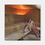 Italy, Tuscany, Young couple relaxing in sauna Magnets