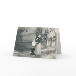 lady with bonnet putting child on seat cards