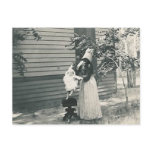 lady with bonnet putting child on seat post card