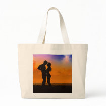 Lovers Kissing at Sunset on the Beach Bags