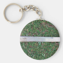 Machete on a grassy ground keychains