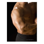 Male bodybuilder flexing muscles, front view, 2 postcards