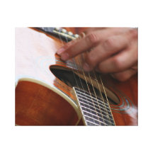 male hand holding pick on acoustic guitar canvas prints
