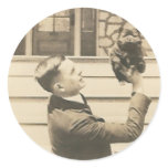 man holding up small animal with one hand stickers