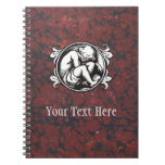 Medieval child (boy) against vintage marble notebooks
