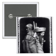 Navaho woman carrying a papoose on her back pins
