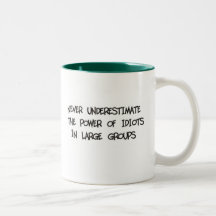 Never underestimate the power of idiots coffee mug