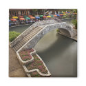 Outdoor cafe along River Walk and bridge over magnets