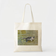 Penguin going swimming tote bags