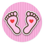 Pink cartoon baby girl feet with red hearts stickers