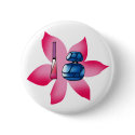 Pink lip gloss and a blue perfume buttons