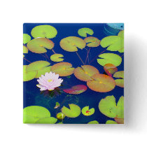 Pink Lotus Flower floating with lily pads on pond