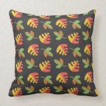 red and yellow , earthy tone leaves on black pillows