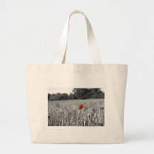 red poppy in a black and white field bag