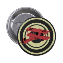 red vintage biplane on bull's eye pin button