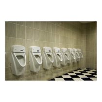 restroom interior with urinal row posters